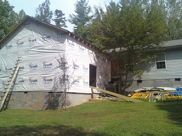 Tyvek wrapped gable on a new room addition beside an existing home in Flagstaff