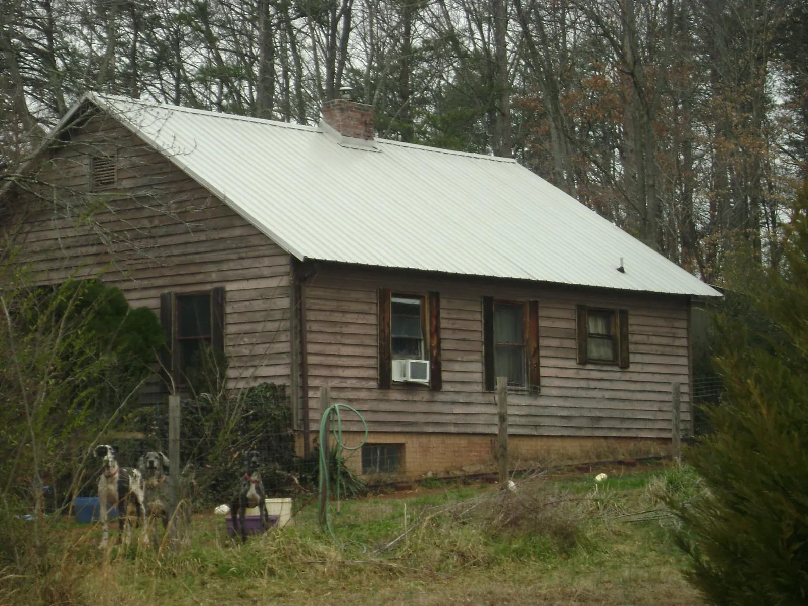 White metal roof on an old wood sided farmhouse, from a Metal Roof Installation job in Flagstaff